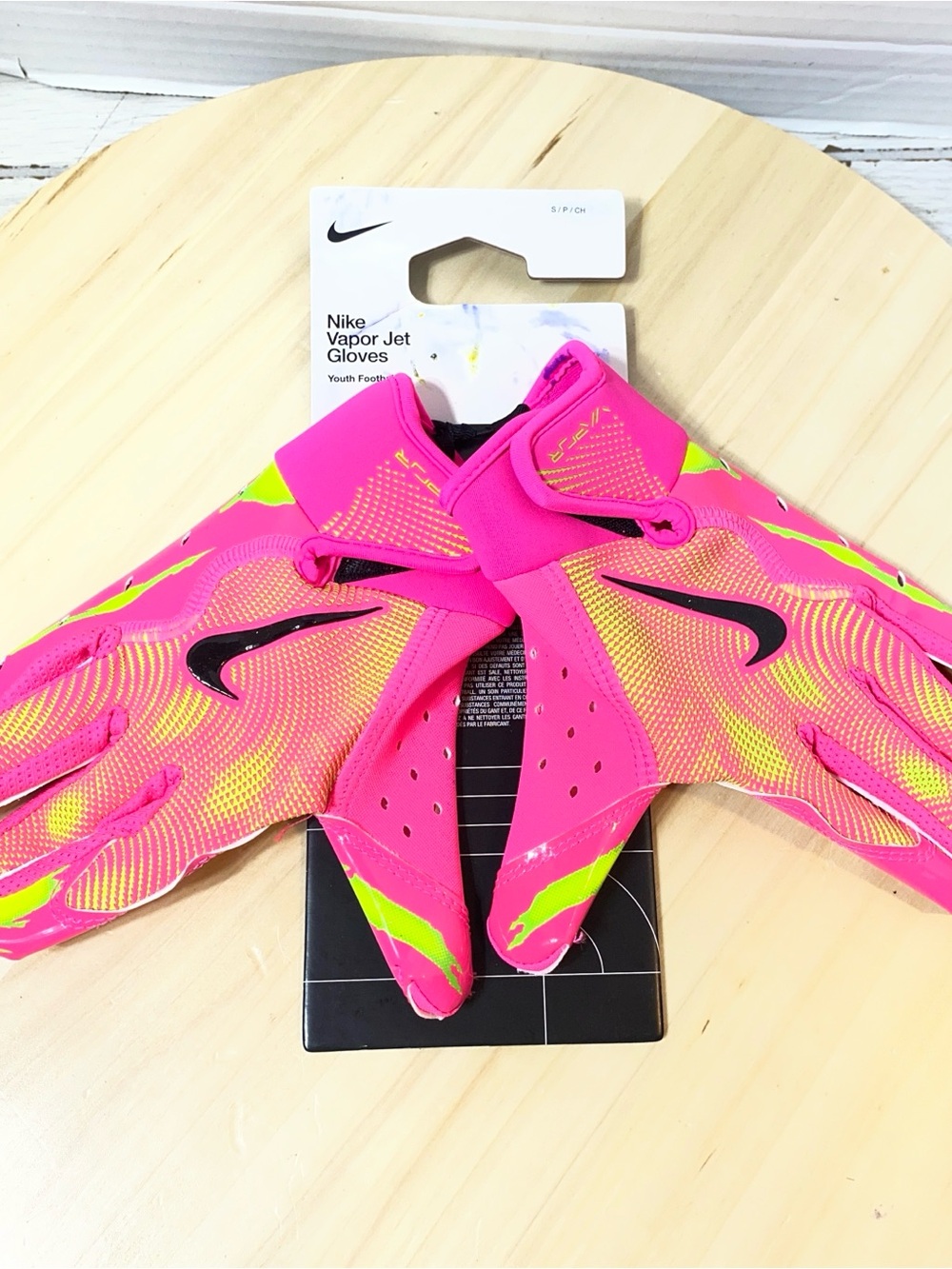 Nike Vapor Jet 7.0 football gloves in a vibrant pink and neon yellow